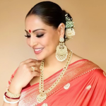 Bipasha Basu viral reel in red saree with toddler tugging at saree during Dussehra celebration.