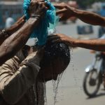 Intense Pakistan weather heatwave in Shaheed Benazirabad showing thermometer at 46 degrees.