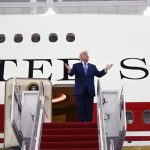 President Donald Trump waving from the steps of the Trump new Air Force One, a refurbished $400 million luxury Boeing 747 gifted by Qatar, at Joint Base Andrews.