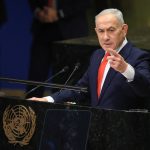 Benjamin Netanyahu addresses the UN General Assembly as delegates walk out