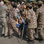 Delhi Detains More Than 2,000 Protesters as ‘Cockroach’ Movement Leaders Are Held Security personnel detain protesters during the Cockroach Janta Party demonstration in New Delhi.