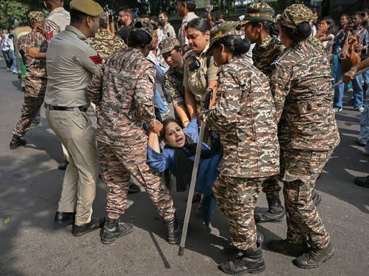 Security personnel detain protesters during the Cockroach Janta Party demonstration in New Delhi.