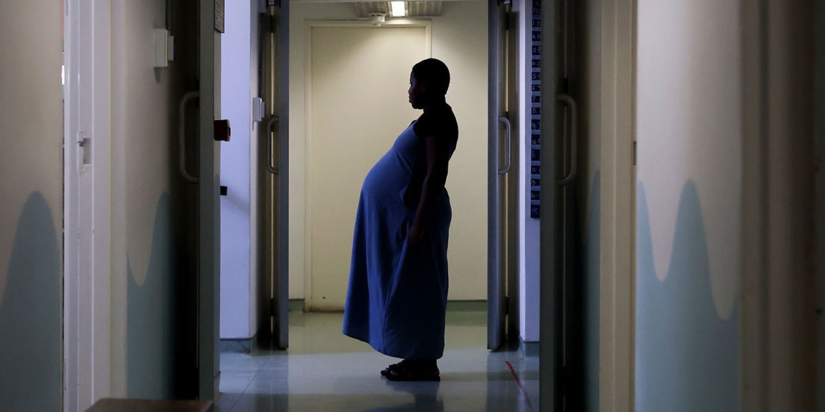 Pregnant woman experiencing extreme heat during a summer heatwave